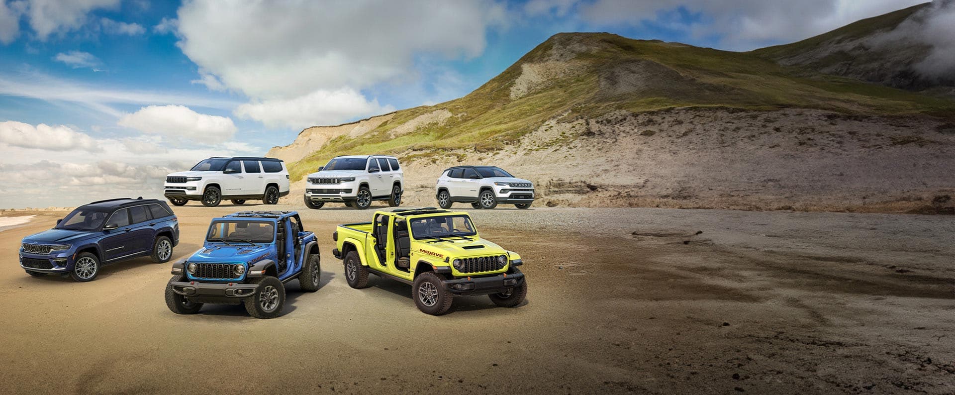 2025 Jeep Wrangler, Gladiator, Wagoneer, Cherokee and Grand Wagoneer parked on the beach 