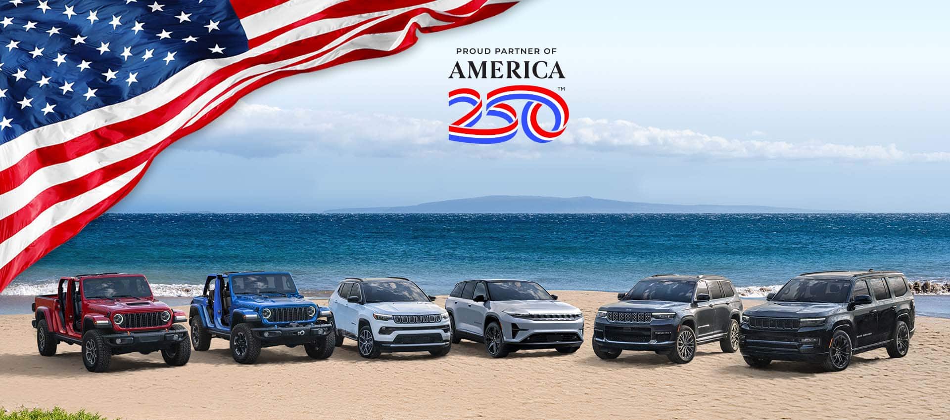 A lineup of six 2025 Jeep Brand vehicles parked on a sandy beach beside the water. From left to right: a red Gladiator Mojave X and blue Wrangler Rubicon X 4xe--both with their doors removed, a white Compass Limited, a silver Wagoneer S Launch Edition, a gray Grand Cherokee Summit Reserve and a black Grand Wagoneer Obsidian.