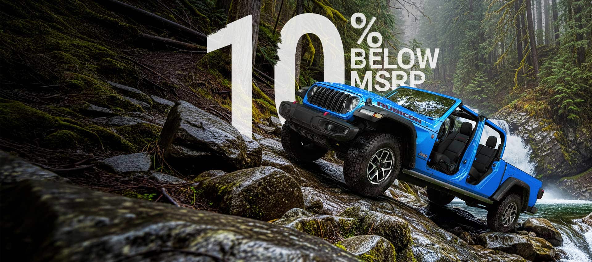 A blue 2026 Jeep Gladiator Rubicon with its doors and top removed, parked on a steep, rocky trail, just above a rapid stream with a waterfall in the background.
