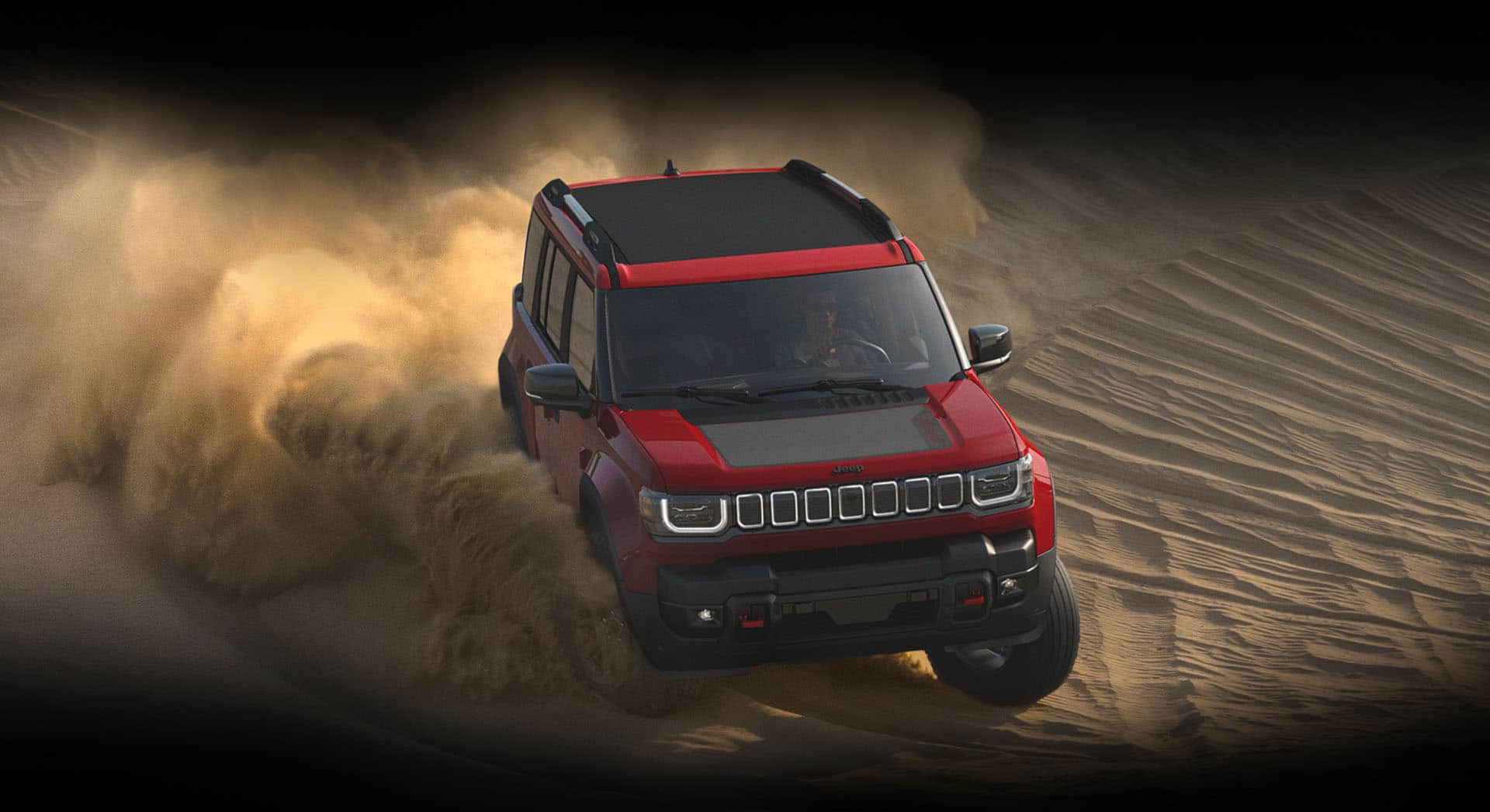 A red 2026 Jeep Recon Moab with a black power-retractable top and black hood insert, plowing through a sand dune, with clouds of sand billowing from its tires.