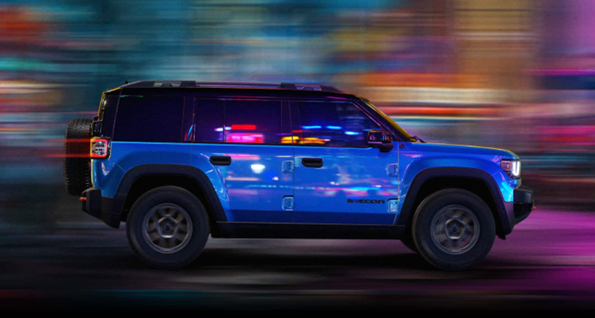A blue 2026 Jeep Recon Moab in profile with the background blurred to indicate the vehicle is in motion.