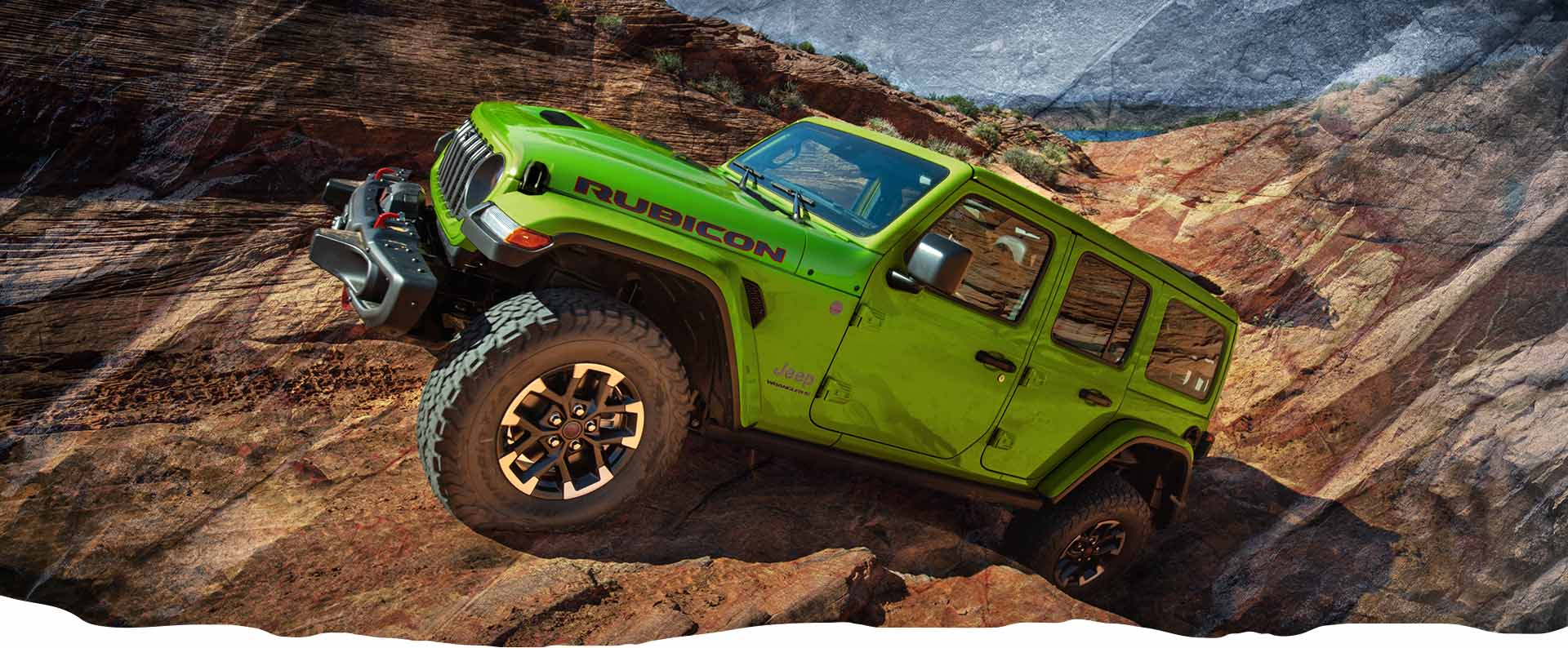 Un Jeep Wrangler Rubicon X 2026 verde lima que avanza lentamente por un sendero rocoso extremo fuera de la carretera.