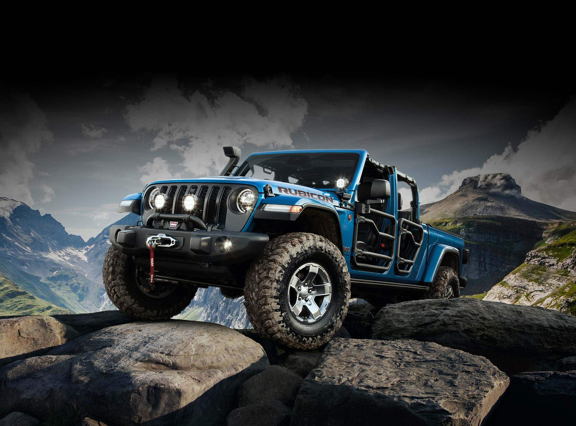 The Jeep Gladiator Rubicon with tube doors, being driven off-road over boulders.