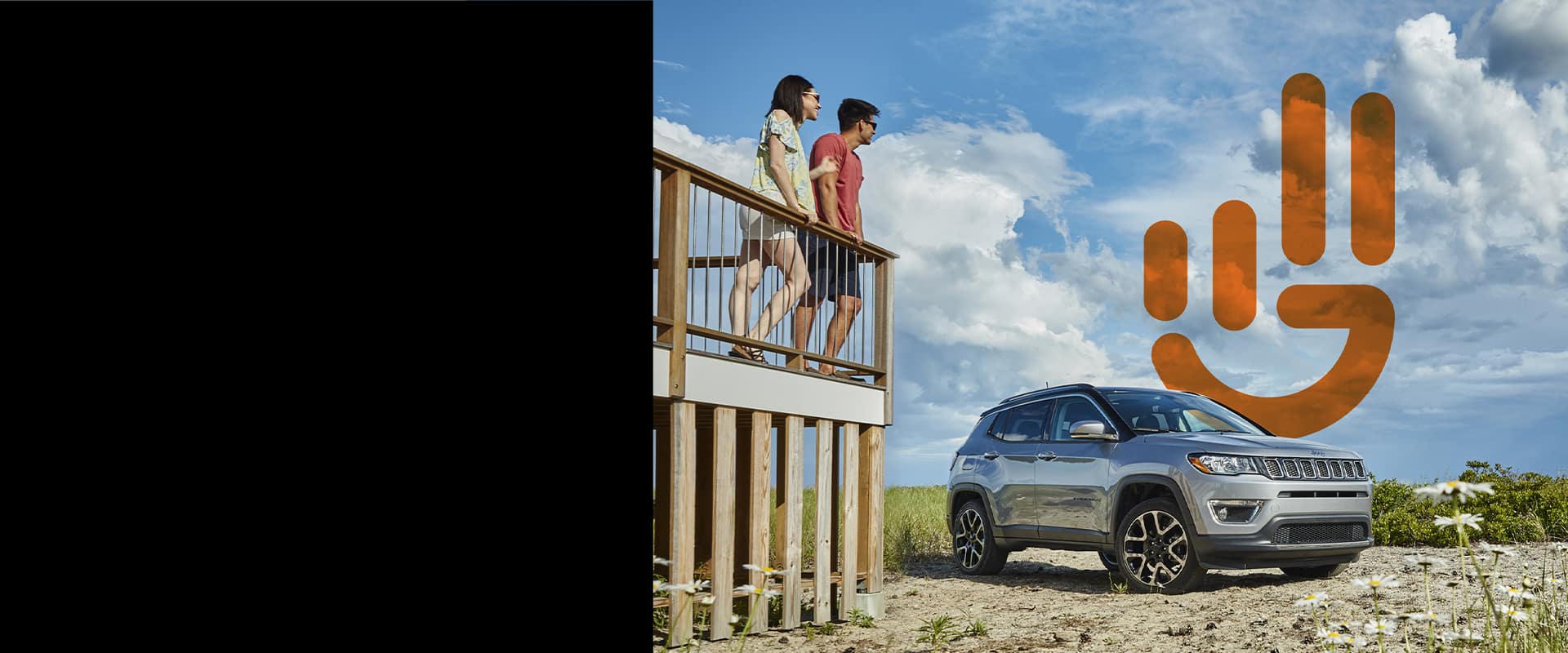 A couple standing on a deck overlooking a parked 2021 Jeep Compass with the Jeep Wave logo superimposed on the image.
