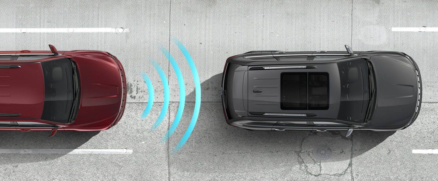 The Jeep Grand Cherokee WK Laredo X with illustrated sensor bars coming from its hood, detecting a vehicle ahead of it.