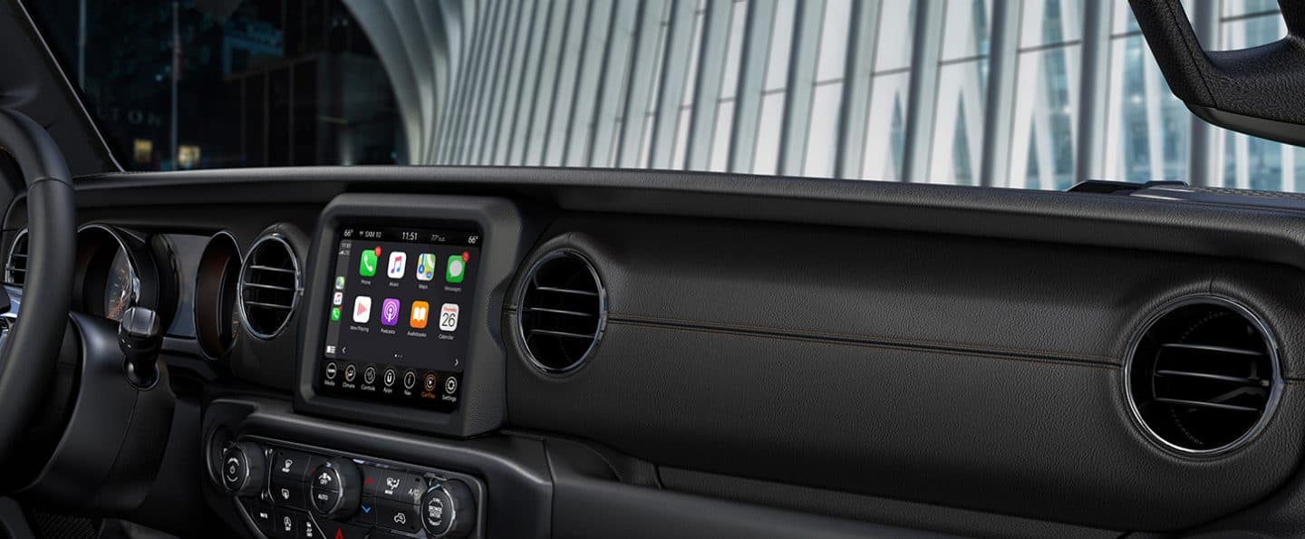 The Uconnect 8.4-inch touchscreen and vents in the interior of the 2021 Jeep Wrangler High Altitude.