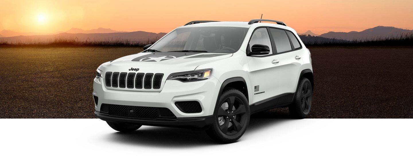 A three-quarter front view of a 2021 Jeep Cherokee Freedom Edition in Bright White, one of five selectable colors.