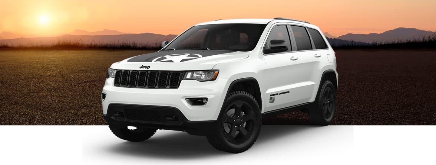 A three-quarter front view of a 2021 Jeep Grand Cherokee Freedom Edition in Bright White, one of four selectable colors.