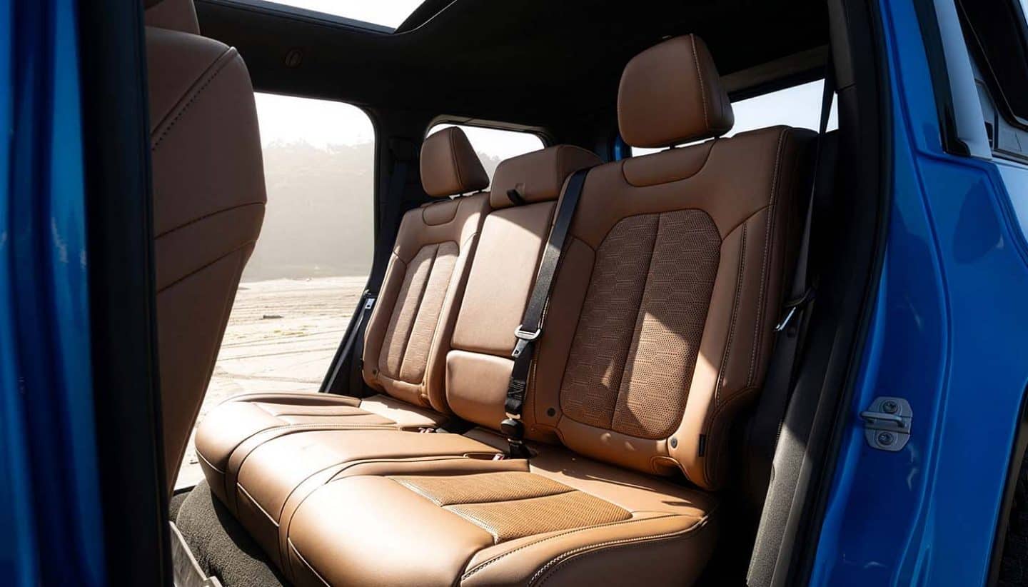 Display The rear seats in a 2026 Jeep Recon with its doors removed.