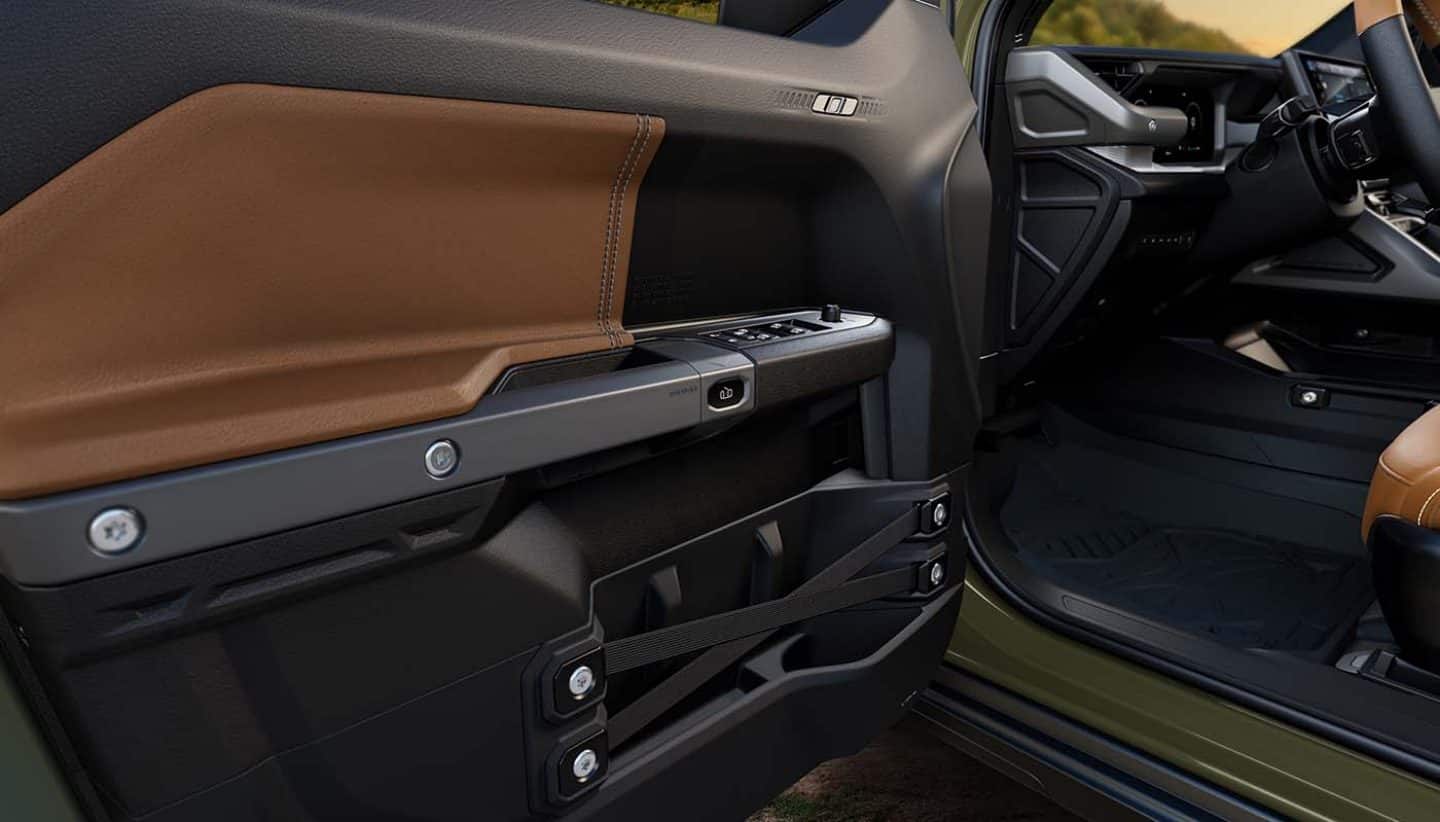 Display The interior side of the driver's door in the 2026 Jeep Recon.