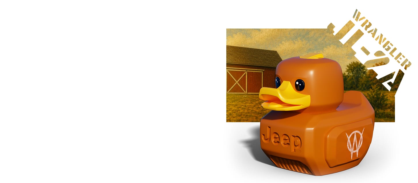 An orange rubber duck with the Jeep logo on the front and a Willys Overland logo on the side sits on a white background. Superimposed behind it is a shot of a red barn in a grassy field and the words WRANGLER and JL-2A.
