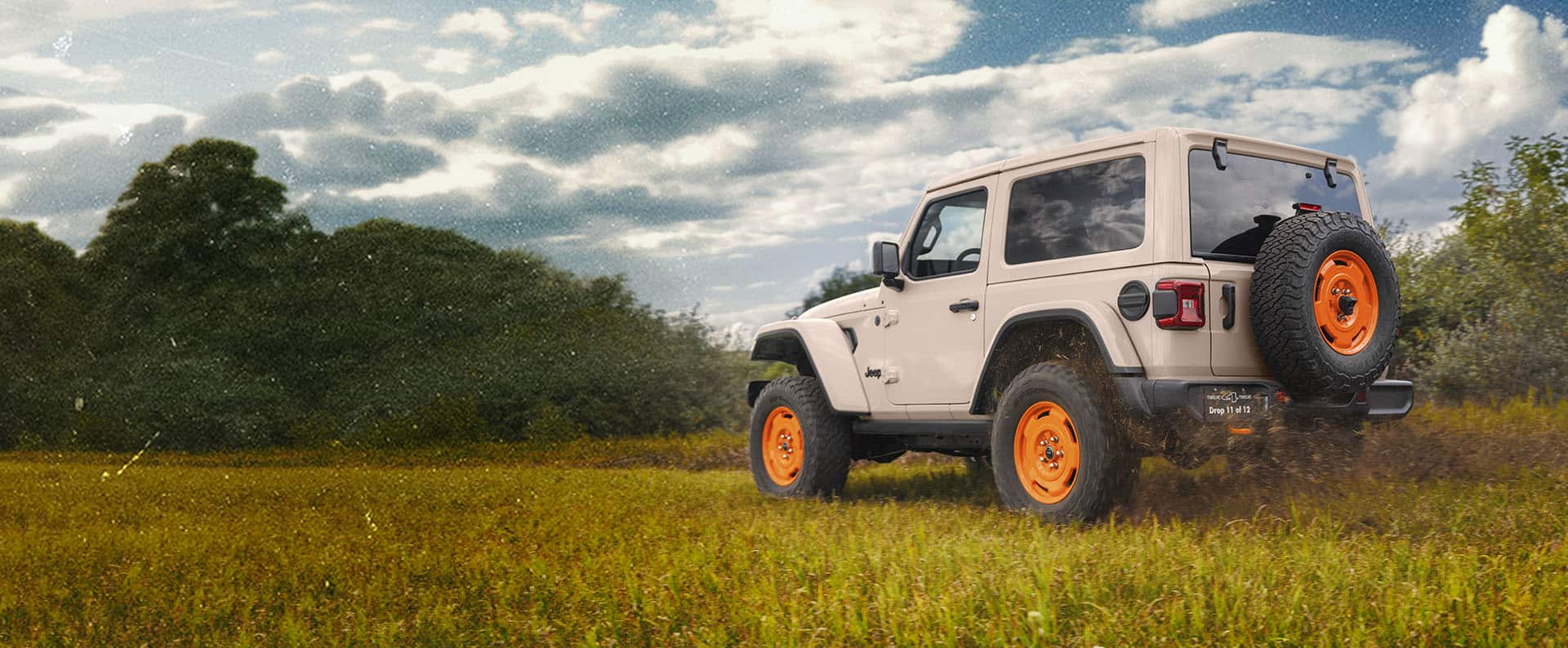 A 2027 Jeep Wrangler JL-2A sits in a grassy field.