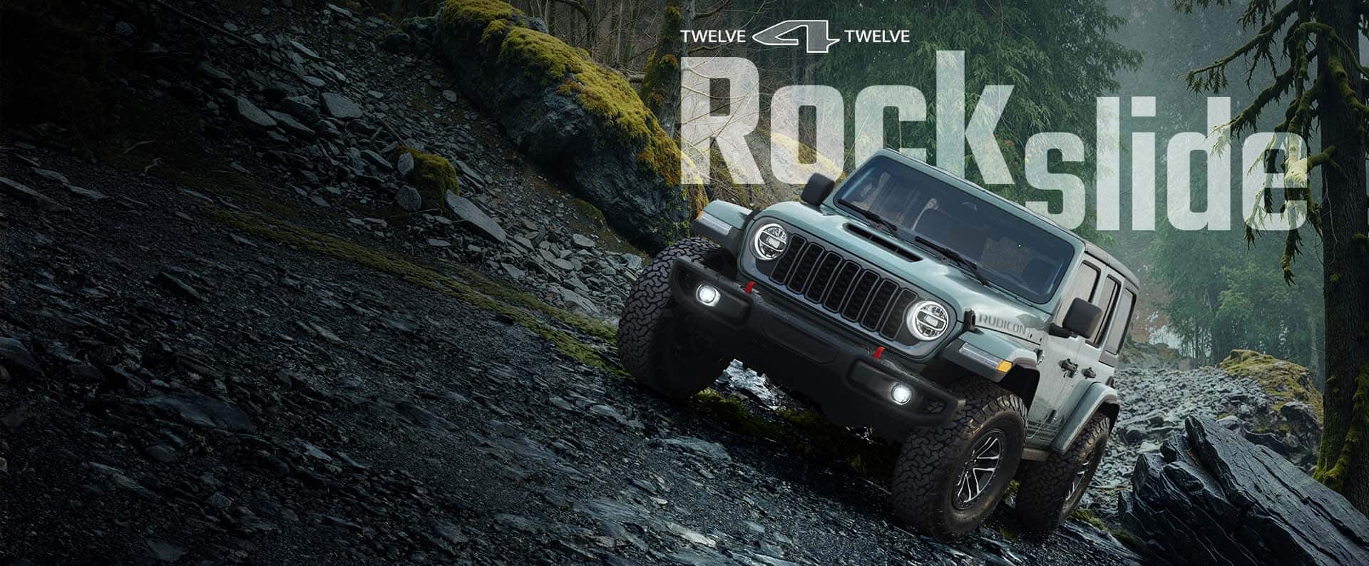 Un Jeep Wrangler Rubicon Rockslide 2026 verde azulado trepando por un sendero todoterreno empinado y rocoso. 12 por 12. Rockslide.