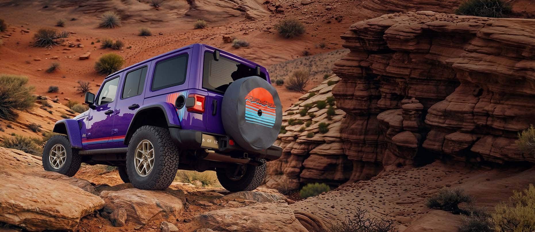 A purple 2026 Jeep Wrangler Rewind four-door with red and blue hood, fender and door decals, parked on a rocky ledge in the mountains.