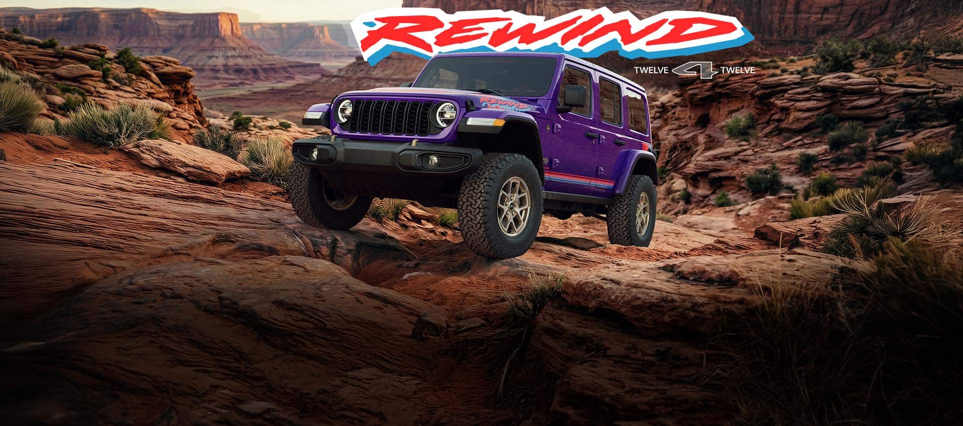 A purple 2026 Jeep Wrangler Rewind four-door with red and blue hood, fender and door decals, ascending a rocky hill off-road. Rewind. 12 for 12.