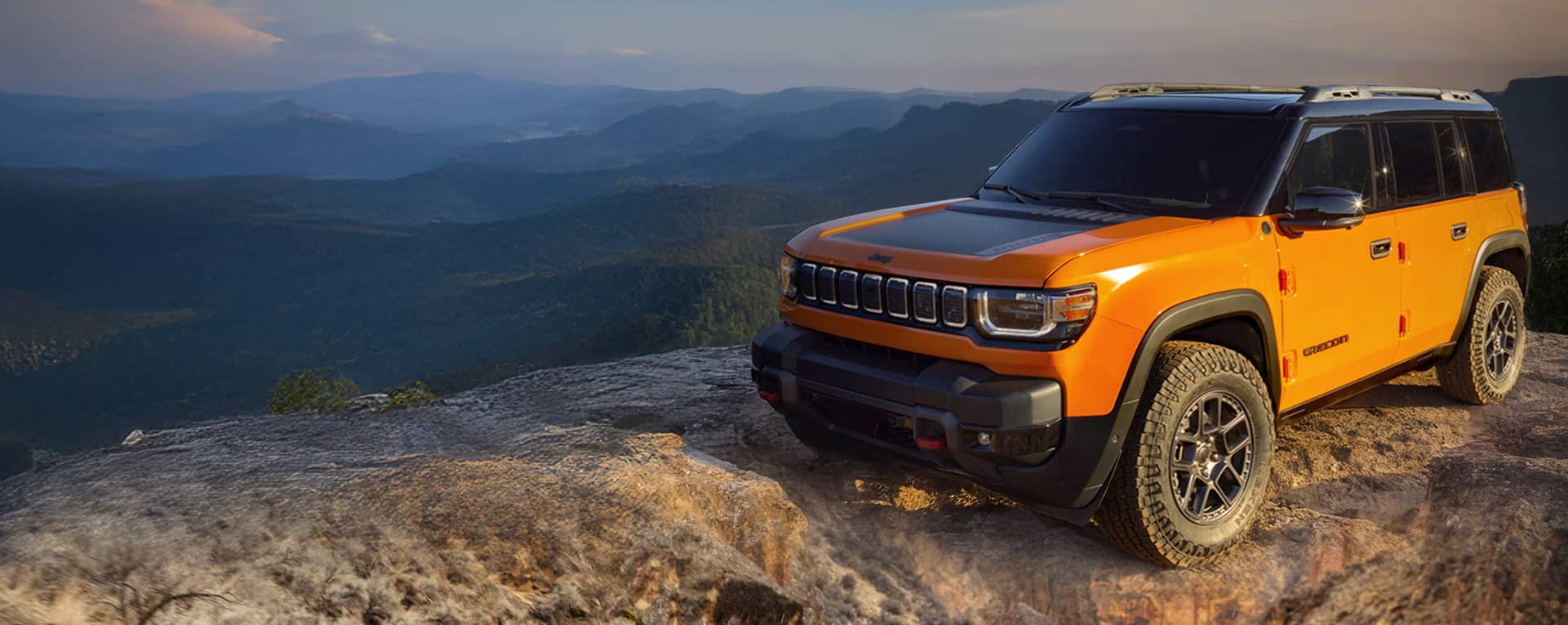 A raised front end angle of the 2026 Jeep Recon preproduction model with a black hood insert.