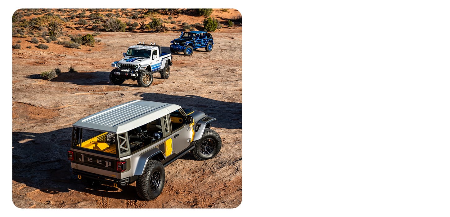 A group of three Jeep Concept vehicles parked on a clearing in the desert.