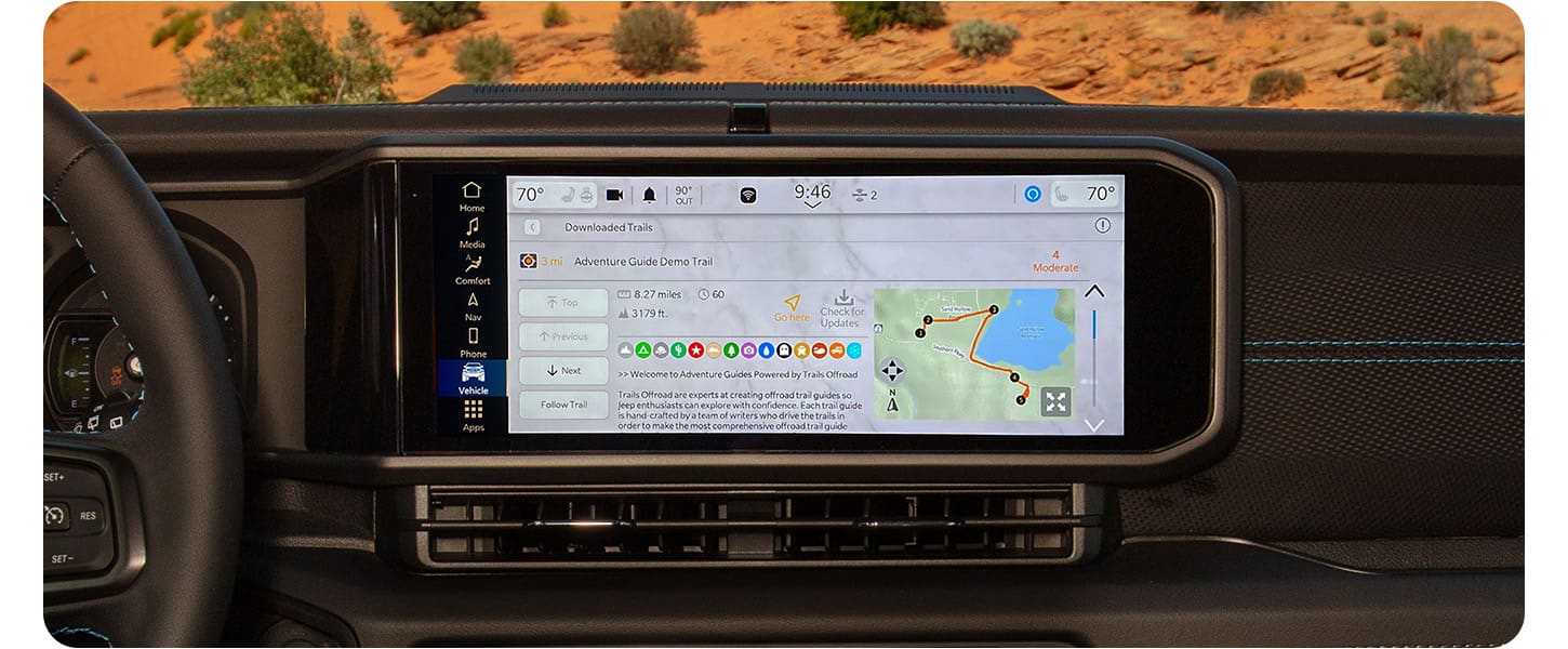 The Uconnect touchscreen in a 2024 Jeep Wrangler displaying an Off-Road Trail Guide from Trails Offroad.